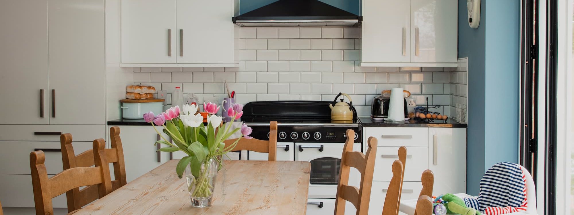 Bright kitchen with flowers on table