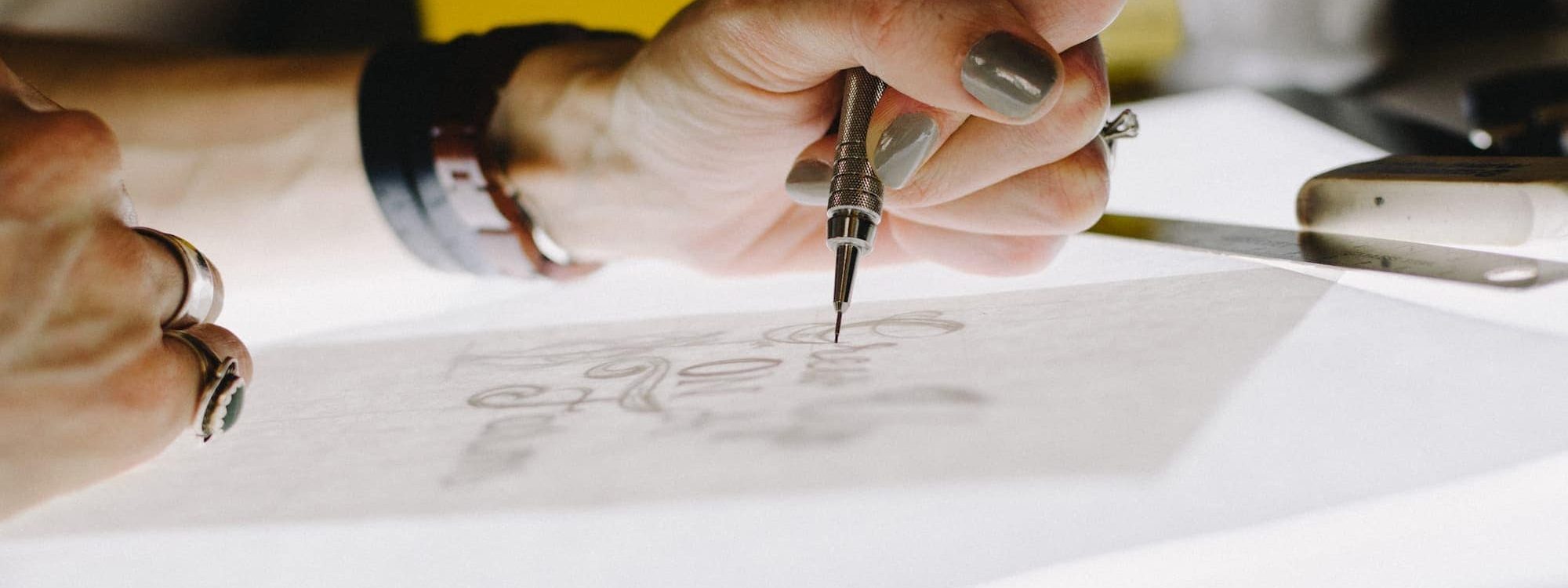 Person sketching typography