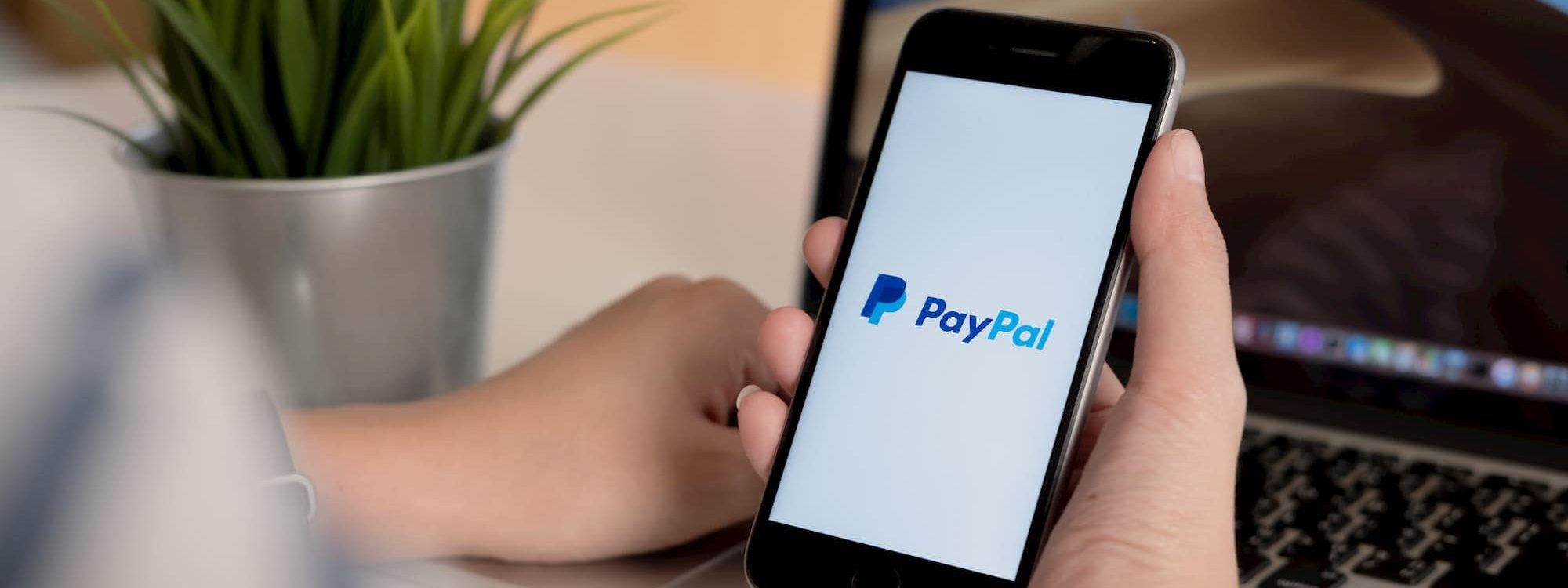 Person opening the PayPal app on phone