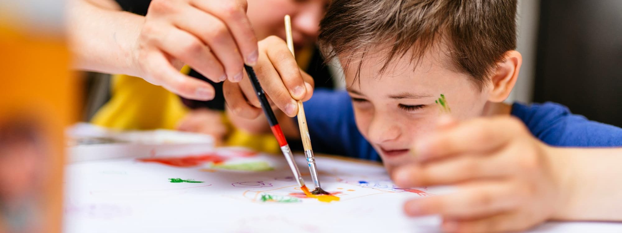 Student and teacher at special school doing arts and crafts